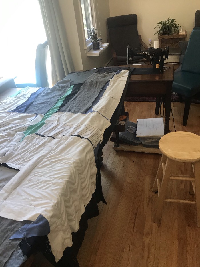 I rolled the sewing machine cart back along the edge of the table as I stitched up the seam between the liner and the shell. I’m pretty proud of that solution.