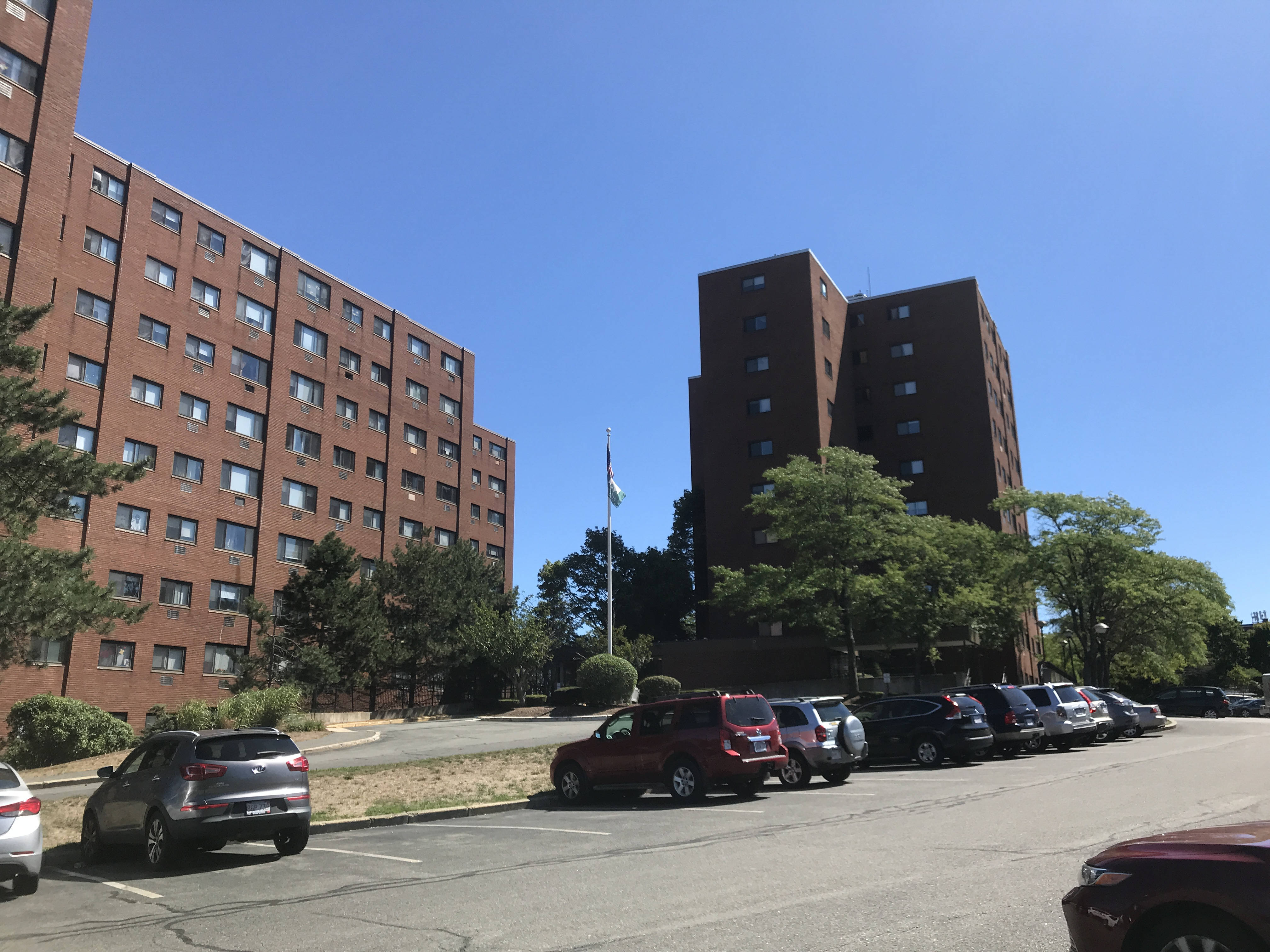 A view from the Salem Heights parking lot, showing two large rectangular brick buildings, approximately eight stories high