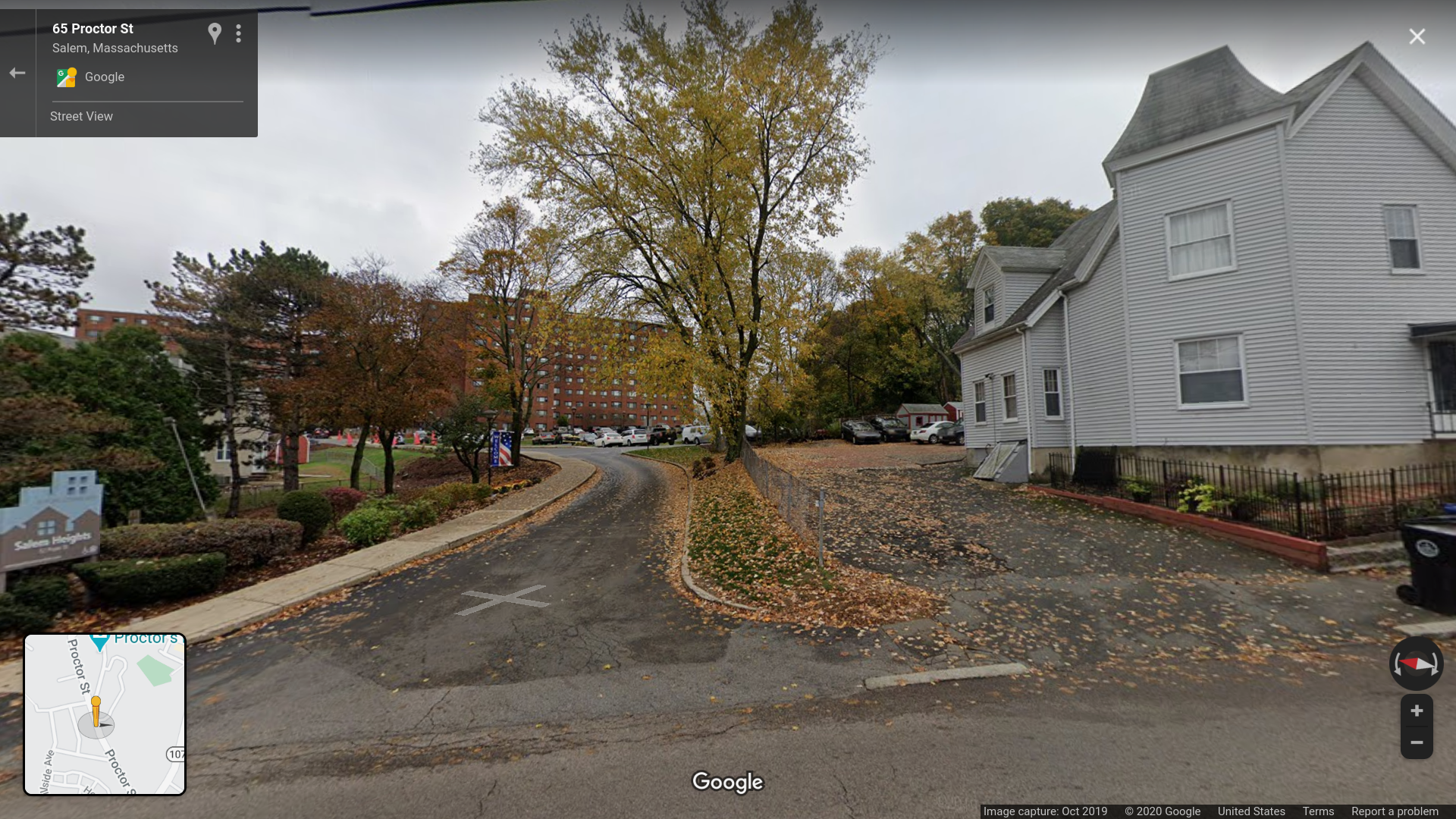 A google street view of the end of the driveway, looking up towards a brick building.